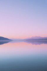 glassy lake reflects pastel sky at dawn light creating serene and minimalistic image with ample copy space