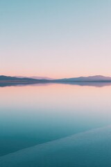 Fototapeta premium glassy lake reflects pastel sky at dawn light creating serene and minimalistic image with ample copy space