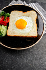Fried gashouse eggs in bread egg in the basket delicious snack breakfast in a bowl fresh delicious gourmet food background on the table rustic food top view copy space