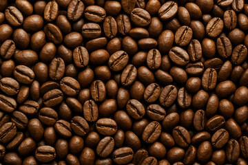 Naklejka premium A close-up view of roasted coffee beans, showcasing their rich brown color and smooth textures