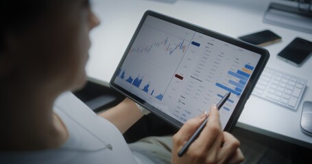 Female Stock Exchange Broker Monitoring and Analyzing Real-Time Stocks, Market Charts in Online...