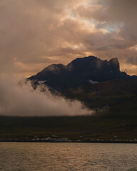 Dramatic clouds over Borgarfjörður Eystri village at sunset, East Iceland...