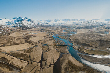 Aerial view of snow-capped mountains and winding rivers in Borgafjordur Eystri, East Iceland...