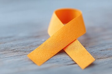 Obraz premium minimalistic orange ribbon on wooden table symbolizes world hepatitis day