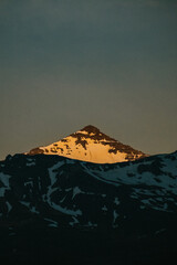 Golden hour light over snow-capped peaks in Faskrudsfjordur, East Iceland...