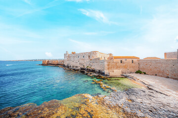 Ortigia island, old cityspace town with turquoise sea of Syracuse. Small island on Sicily, Italy. Castello Maniace