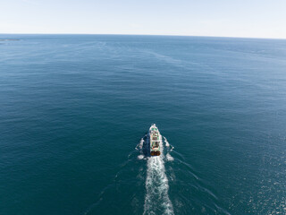 Cargo ship sails near Skrudur island in Faskrudsfjordur, East Iceland...