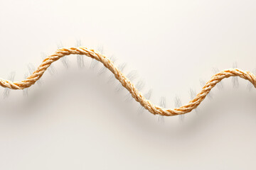 Obraz premium Closeup of twisted rope with frayed ends, showcasing its texture and natural fibers, creating organic and rustic feel