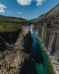 Aerial view of basalt columns and blue river in Studlagil Canyon, Iceland...