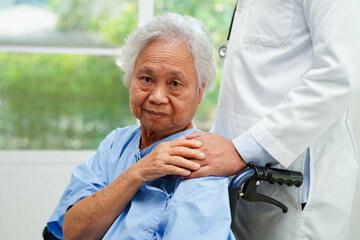 Doctor holding hands Asian elderly woman patient, help and care in hospital.