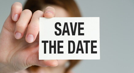 Save the date text concept, Save the date in hand concept of text on sticky note
