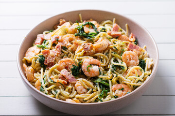 Prawn and bacon pasta with spinach. Spaghetti