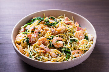 Prawn and bacon pasta with spinach. Spaghetti