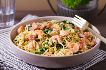 Prawn and bacon pasta with spinach. Spaghetti