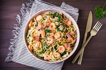 Prawn and bacon pasta with spinach. Spaghetti. View from above, top view