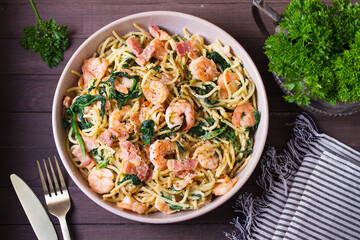 Prawn and bacon pasta with spinach. Spaghetti. View from above, top view
