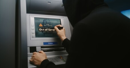 Unrecognizable Man, Vandal Drawing Obscene Drawings on Out of Service Cash Machine. Person in...