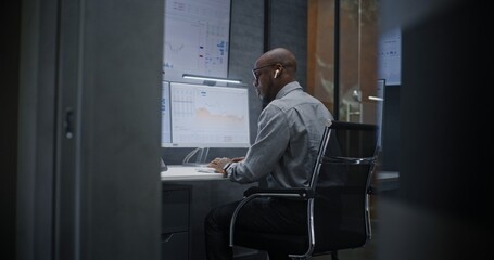 Stock Broker Shouting During Call, Soaking Financial Loss, Monitoring Real-Time Stocks and Exchange Market Charts in Office at Night. African American Investment Agent Angry About Bad Economy News.