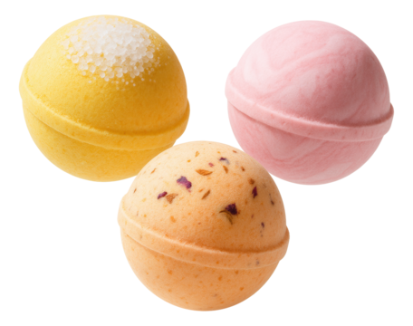 Three colorful bath bombs in yellow, pink, and orange hues featuring decorative textures on transparent background.
