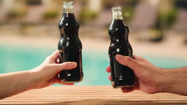 Cola opening and cheers, drinks, people and lifestyle concept - close up of happy woman drinking cola in sunset beach bar in hotel. 