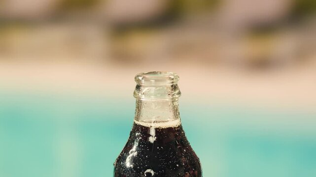 Cola opening and cheers, drinks, people and lifestyle concept - close up of happy woman drinking cola in sunset beach bar in hotel. 