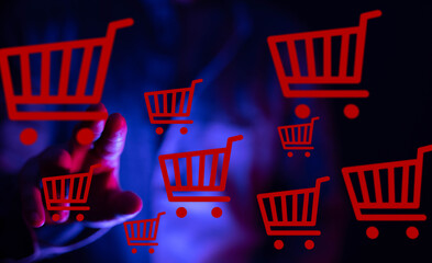 Abstract image of a hand interacting with digital shopping carts, representing online shopping and...
