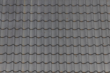 Roof grey tiles as background.