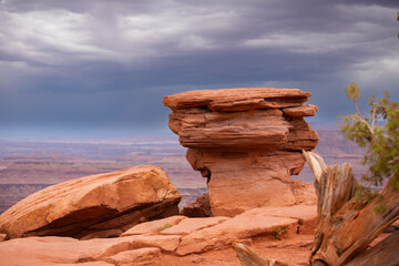 Storm clouds behind a red rock formation in Canyonlands National Park, Utah, USA