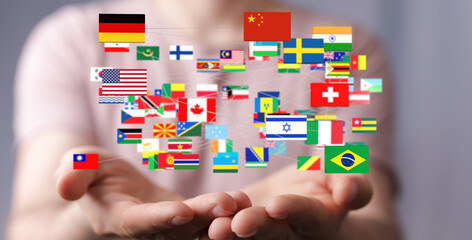 Image of hands holding a network of diverse flags, symbolizing global connections and international...