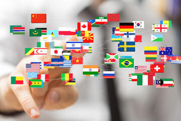 A hand interacts with a network of flags representing global connections and international...