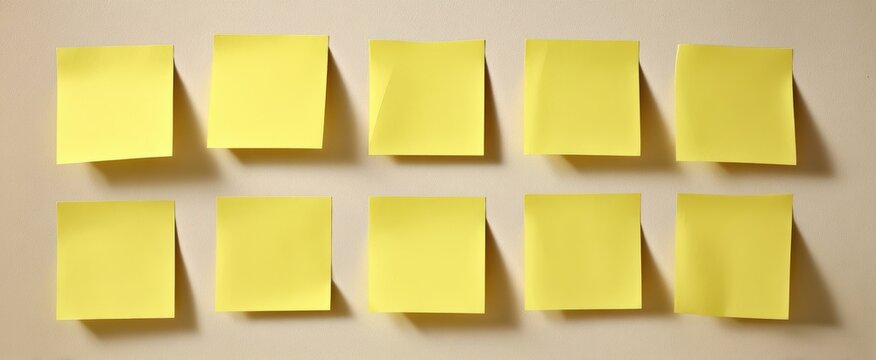The collection of blank yellow sticky notes on a simple background.
