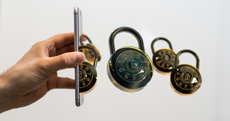 Image of a hand holding a smartphone with multiple combination locks floating nearby, symbolizing...