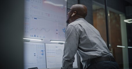 Stock Exchange Trader Shouting During Call, Soaking Financial Loss, Monitoring Exchange Market Charts on Multi-Monitor Computer in Office. African American Investment Agent Angry About Economy News.