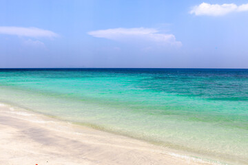 Koh Lipe, Thailand. A tranquil scene of the Andaman Sea meeting a white sand beach under a sunny sky, the beauty of this tropical island.