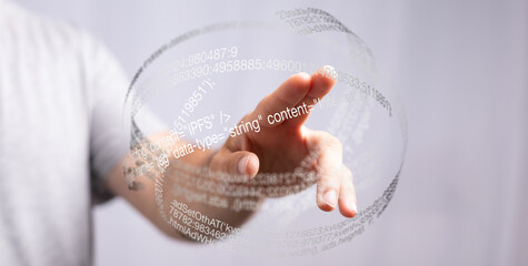 Abstract image of a hand interacting with a sphere of data, representing digital technology and...