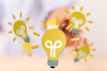 Person interacting with glowing lightbulbs, symbolizing new ideas and innovation.