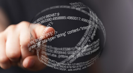 Close-up of a hand interacting with a transparent sphere filled with digital data, code, and...