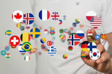 Person interacting with a digital display of world flags, symbolizing international communication.