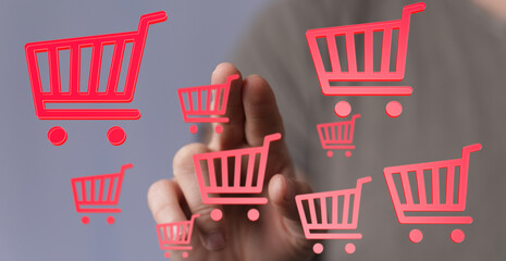 Person interacts with virtual shopping carts, symbolizing online shopping, e-commerce, and digital...