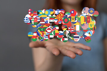 Image of diverse national flags in a hand, representing global unity and international cooperation.