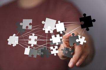 Abstract image of interconnected puzzle pieces, symbolizing teamwork, collaboration, and...