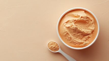 Fototapeta premium Creamy orange food in bowl, powder beside