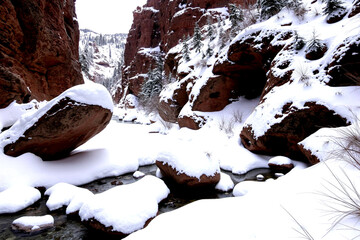 Snowy Serenity: A Winter Wonderland of Rocky Cliffs and Frozen Creek
