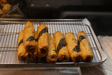Korean fried seaweed-wrapped fish cakes, appetizing street food display, traditional snack on metal rack, Seoul, South Korea, Myeongdong Market