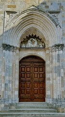 carved door of an old church in Italy