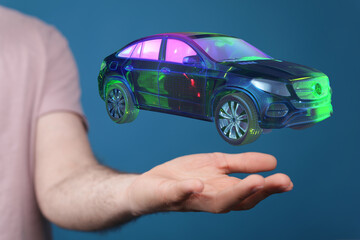 Person holding a digital car hologram.  Innovation, future of driving, technology.