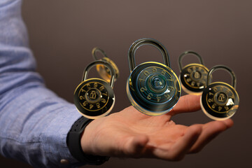 Image of multiple digital combination locks floating above a hand, symbolizing data security and...