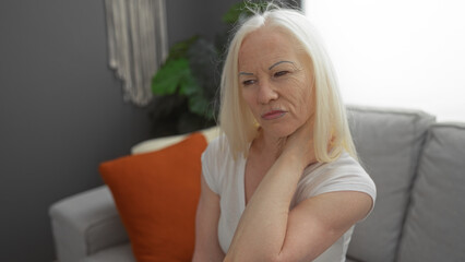 Woman with albinism in a living room setting, showcasing thoughtful expression while seated on a...