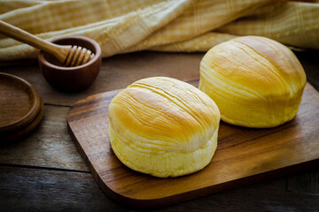 Fresh baked buns on wooden board