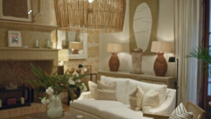 Cozy living room featuring blurred decor, plants, and soft lighting with natural textures and earth tones creating a warm, inviting atmosphere perfect for relaxation at home.